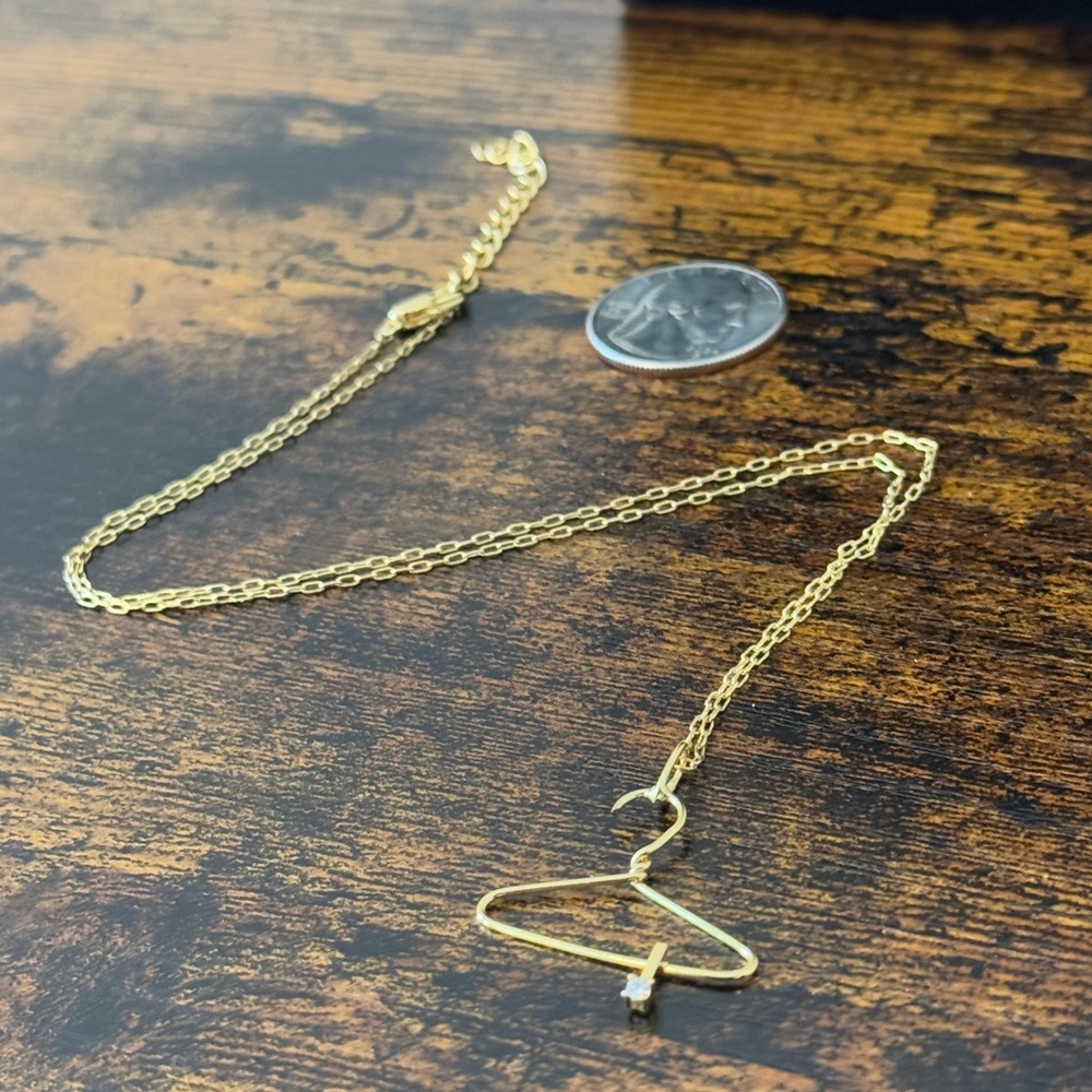 14k gold plated necklace with a unique hanger pendant and diamond detail.